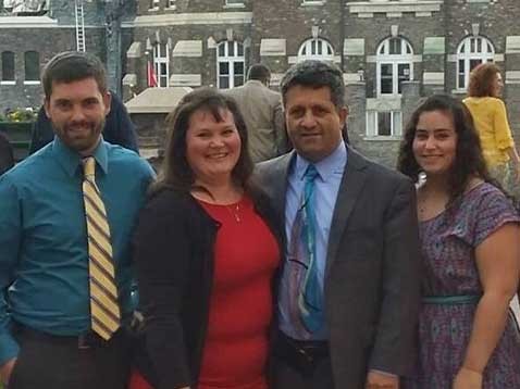 Business owner and family standing in a row