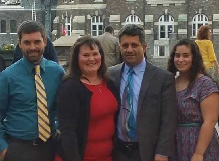 Business owner and family standing in a row