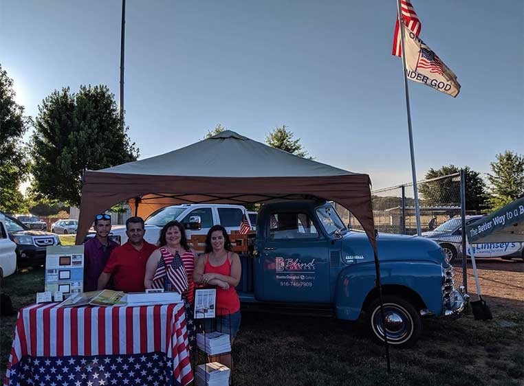 The business owner and family at their fair booth